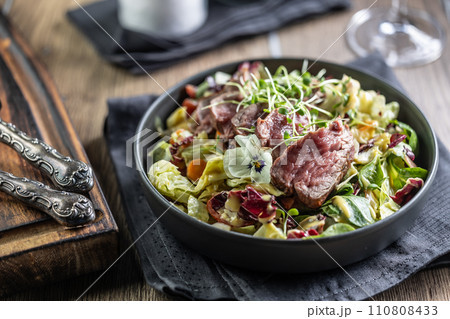 Fillet of beef sirloin with lettuce salad in plate on pub or restaurant 110808433