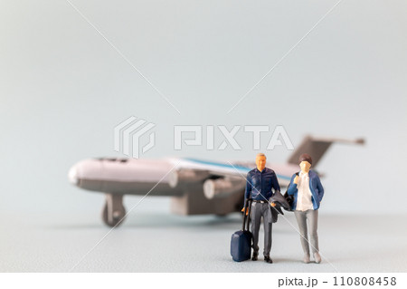 Miniature people, travelers embarks on a delightful vacation, gleefully boarding a tiny airplane 110808458