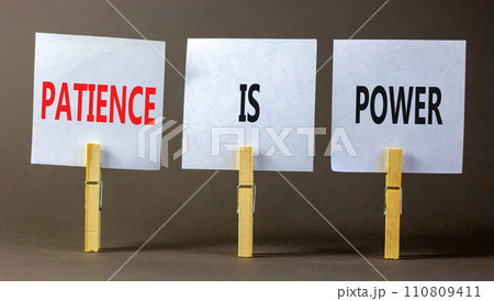 Patience is power symbol. Concept words Patience is power on beautiful white paper on clothespin. Beautiful grey table grey background. Business and patience is power concept. Copy space. 110809411
