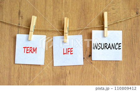 Term life insurance symbol. Concept words Term life insurance on beautiful white paper on clothespin. Beautiful wooden table wooden background. Business and term life insurance concept. Copy space. 110809412