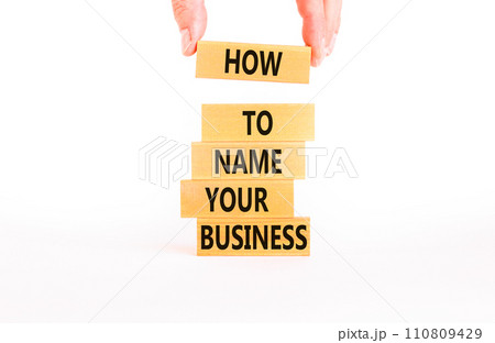How to name your business symbol. Concept words How to name your business on wooden blocks. Beautiful white table white background. Businessman hand. How to name your business concept. Copy space. 110809429