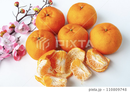 Top view of Pealed Mandarin oranges on white cover background. Chinese New Year celebration. Top view of Pealed Mandarin oranges on white cover background. Chinese New Year celebration. 110809748