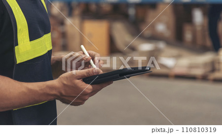 Banner Close up Hispanic men hands using pen touch smart tablet Warehouse management logistics counting checking products on inventory shelf. Man hands worker check stock control with copy space 110810319