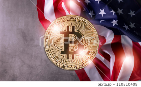 Shiny Physical Bitcoin Against Official United States Flag waved on a grunge gray background. Shiny Physical Bitcoin Against Official United States Flag waved on a grunge gray background. 110810409