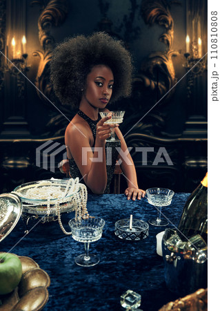 Portrait of elegant African beautiful young woman in luxurious sparkling dress raising glass with champagne. Wealthy lifestyle of youth 110810808