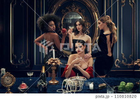 Elegant, beautiful, wealthy young women, friends in stylish clothes attending luxury dinner. Rich lifestyle 110810820