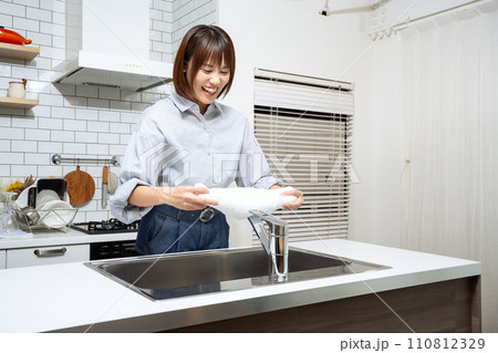 キッチンで拭き掃除をする女性 110812329