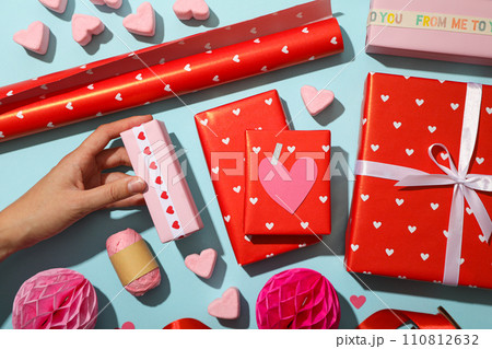 Red gifts on a blue background, concept for Valentine's Day. Red gifts on a blue background, concept for Valentine's Day. 110812632