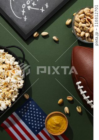 Blackboard with rugby strategy, bowl of popcorn and flag Blackboard with rugby strategy, bowl of popcorn and flag 110812701