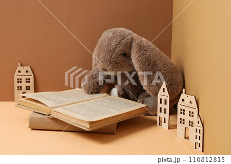 A children's book with toys on a beige background. 110812815