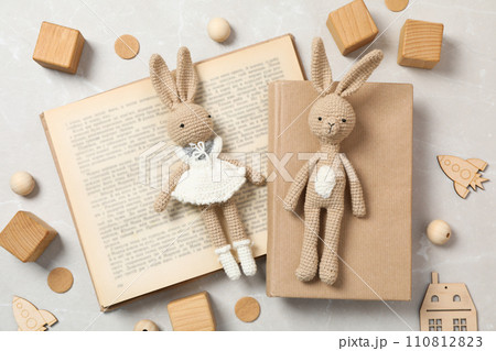 A children's book with toys on a light background. 110812823