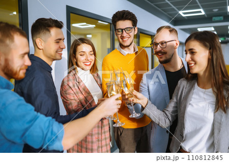 Clinking glasses with champagne. Happy coworkers celebrating their business achievement. Clinking glasses with champagne. Happy coworkers celebrating their business achievement. 110812845