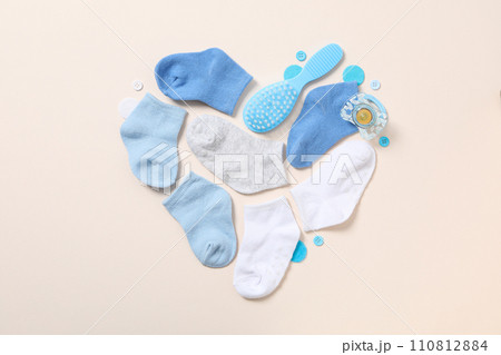 Children's things laid out in the shape of a heart, top view. Children's things laid out in the shape of a heart, top view. 110812884