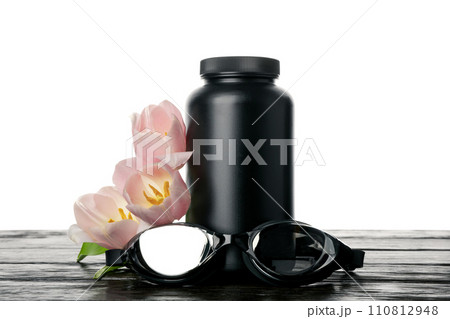 PNG, swimming goggles and pill bottle with flowers, isolated on white background. 110812948