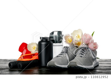 PNG sports goods with flowers on table isolated on white background. 110812952