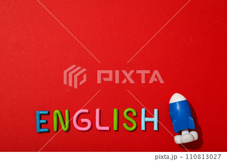 The word English with a rocket next to it, on a red background. 110813027