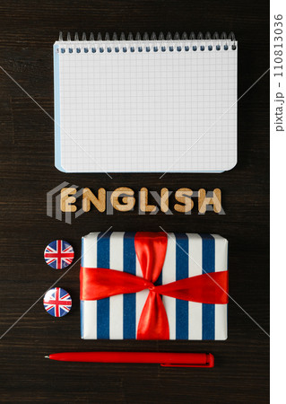 The concept of learning English, a notebook on a blue background. The concept of learning English, a notebook on a blue background. 110813036