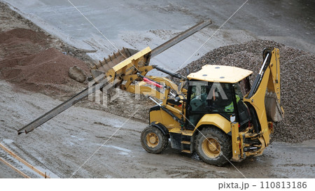 Kiev, Ukraine March 13, 2019: Tractors and excavators work on the construction of the foundation zero cycle Kiev, Ukraine March 13, 2019: Tractors and excavators work on the construction of the foundation zero cycle 110813186