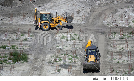 Kiev, Ukraine March 13, 2019: Tractors and excavators work on the construction of the foundation zero cycle Kiev, Ukraine March 13, 2019: Tractors and excavators work on the construction of the foundation zero cycle 110813193