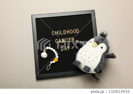 A black board with the inscription Childhood Cancer Day and a penguin 110813410
