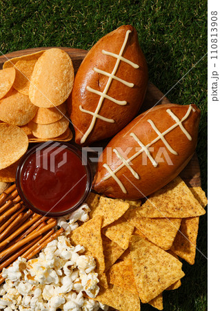 A bowl with various beer snacks on the grass 110813908