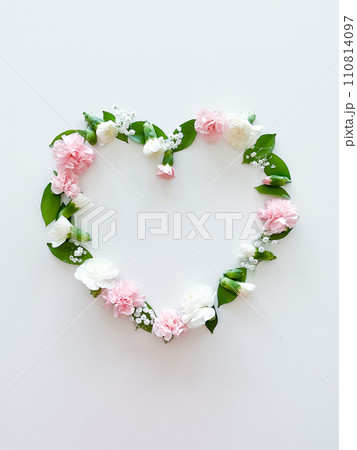Frame in form of heart from pink, white carnations Frame in form of heart from pink, white carnations 110814097