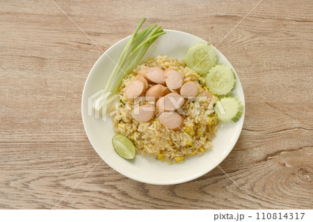 fried rice pork sausage and egg with slice cucumber couple lemon on plate fried rice pork sausage and egg with slice cucumber couple lemon on plate 110814317