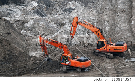Kiev, Ukraine, October 17, 2018: Workers in the mud of a construction site at the stage of excavation; construction of a supermarket AUCHAN Kiev, Ukraine, October 17, 2018: Workers in the mud of a construction site at the stage of excavation; construction of a supermarket AUCHAN 110814354