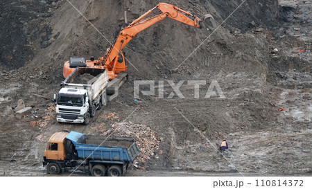 Kiev, Ukraine, October 17, 2018: Workers in the mud of a construction site at the stage of excavation; construction of a supermarket AUCHAN Kiev, Ukraine, October 17, 2018: Workers in the mud of a construction site at the stage of excavation; construction of a supermarket AUCHAN 110814372