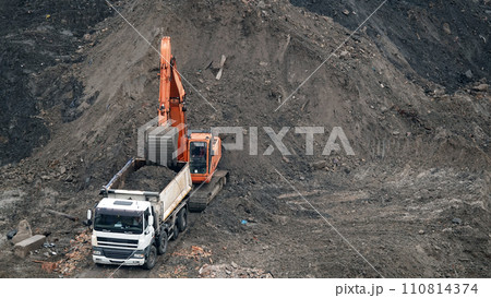 Kiev, Ukraine, October 17, 2018: Workers in the mud of a construction site at the stage of excavation; construction of a supermarket AUCHAN Kiev, Ukraine, October 17, 2018: Workers in the mud of a construction site at the stage of excavation; construction of a supermarket AUCHAN 110814374