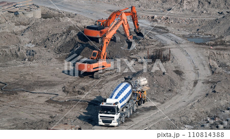 Kiev, Ukraine, October 17, 2018: Workers in the mud of a construction site at the stage of excavation; construction of a supermarket AUCHAN Kiev, Ukraine, October 17, 2018: Workers in the mud of a construction site at the stage of excavation; construction of a supermarket AUCHAN 110814388