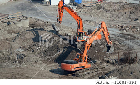 Kiev, Ukraine, October 17, 2018: Workers in the mud of a construction site at the stage of excavation; construction of a supermarket AUCHAN Kiev, Ukraine, October 17, 2018: Workers in the mud of a construction site at the stage of excavation; construction of a supermarket AUCHAN 110814391