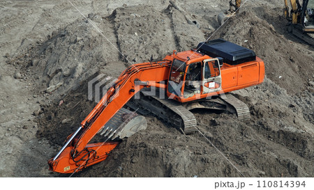 Kiev, Ukraine, October 17, 2018: Workers in the mud of a construction site at the stage of excavation; construction of a supermarket AUCHAN Kiev, Ukraine, October 17, 2018: Workers in the mud of a construction site at the stage of excavation; construction of a supermarket AUCHAN 110814394