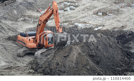 Kiev, Ukraine, October 17, 2018: Workers in the mud of a construction site at the stage of excavation; construction of a supermarket AUCHAN 110814400