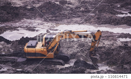 Kiev, Ukraine March 13, 2019: Tractors and excavators work on the construction of the foundation zero cycle Kiev, Ukraine March 13, 2019: Tractors and excavators work on the construction of the foundation zero cycle 110814471