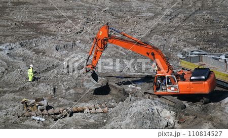 Kiev, Ukraine March 13, 2019: Tractors and excavators work on the construction of the foundation zero cycle Kiev, Ukraine March 13, 2019: Tractors and excavators work on the construction of the foundation zero cycle 110814527