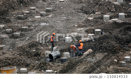 Kiev, Ukraine March 13, 2019: Workers and machinery - zero-cycle construction of the foundation of an entertainment center Kiev, Ukraine March 13, 2019: Workers and machinery - zero-cycle construction of the foundation of an entertainment center 110814533