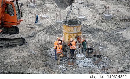 Kiev, Ukraine March 13, 2019: Workers and machinery - zero-cycle construction of the foundation of an entertainment center Kiev, Ukraine March 13, 2019: Workers and machinery - zero-cycle construction of the foundation of an entertainment center 110814852