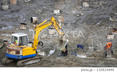 Kiev, Ukraine March 13, 2019: Workers and machinery - zero-cycle construction of the foundation of an entertainment center Kiev, Ukraine March 13, 2019: Workers and machinery - zero-cycle construction of the foundation of an entertainment center 110814949