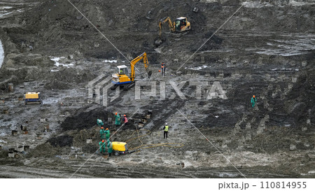 Kiev, Ukraine March 13, 2019: Workers and machinery - zero-cycle construction of the foundation of an entertainment center Kiev, Ukraine March 13, 2019: Workers and machinery - zero-cycle construction of the foundation of an entertainment center 110814955