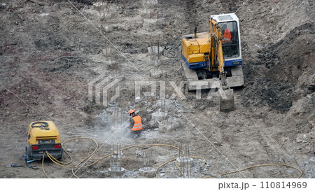 Kiev, Ukraine March 13, 2019: Workers and machinery - zero-cycle construction of the foundation of an entertainment center Kiev, Ukraine March 13, 2019: Workers and machinery - zero-cycle construction of the foundation of an entertainment center 110814969
