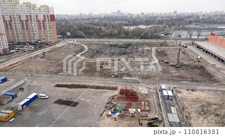 Kiev, Ukraine March 13, 2019: Tractors and excavators work on the construction of the foundation zero cycle Kiev, Ukraine March 13, 2019: Tractors and excavators work on the construction of the foundation zero cycle 110816381