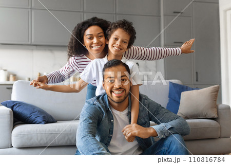 Portrait Of Happy African American Parents Bonding With Their Son At Home 110816784
