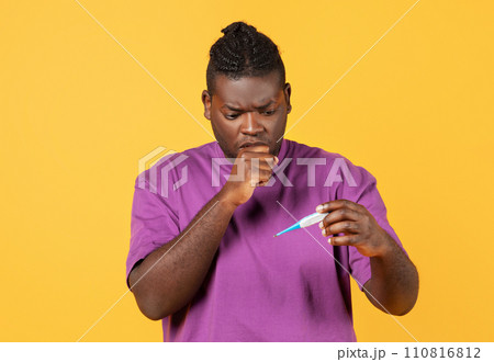 Ill african american guy coughing holding thermometer over yellow background 110816812