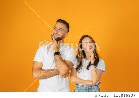 Happy pensive young european guy and woman think, look at free space 110816837