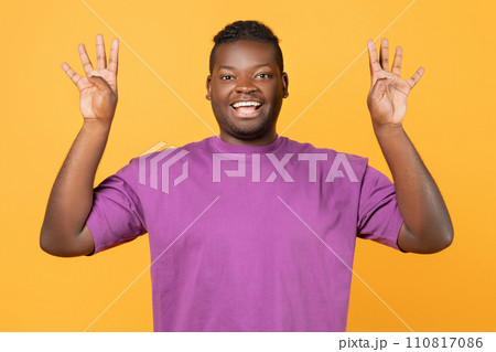 African American man raising hands showing number eight, yellow background African American man raising hands showing number eight, yellow background 110817086