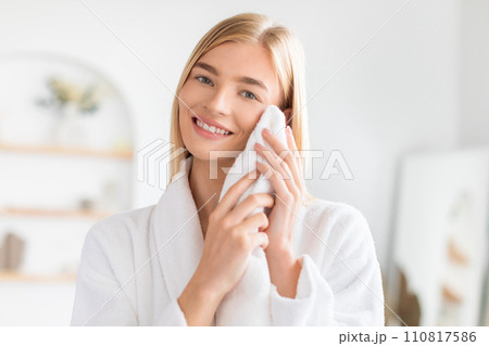 Smiling Blonde Lady Drying Her Clean Face With Towel Indoor 110817586