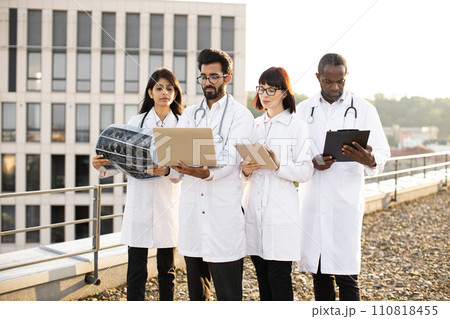 Arabian doctor using laptop showing results of patient's tests. Arabian doctor using laptop showing results of patient's tests. 110818455