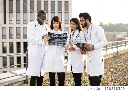 Doctors discussing x-ray image. 110818599