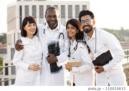 Portrait of team of multinational doctors in white coats with stethoscopes Portrait of team of multinational doctors in white coats with stethoscopes 110818615
